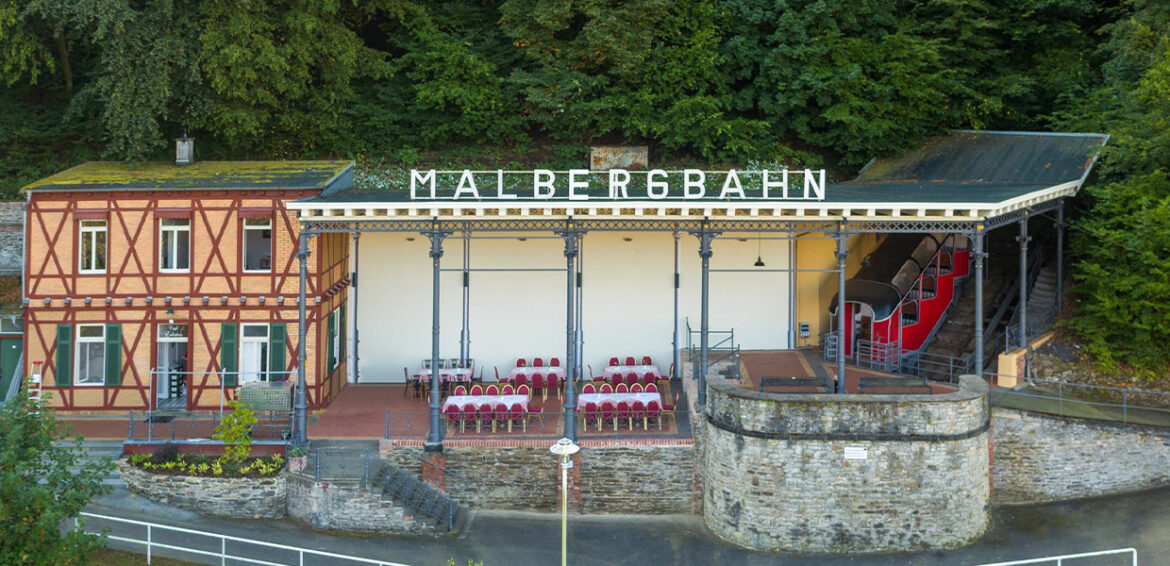 Talstation der Malbergbahn mit Fachwerkgebäude und Bahnsteig.