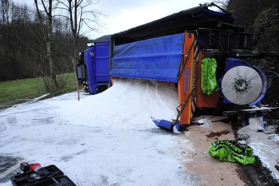 Umgekippter LKW mit Salzladung auf einer Landstraße.