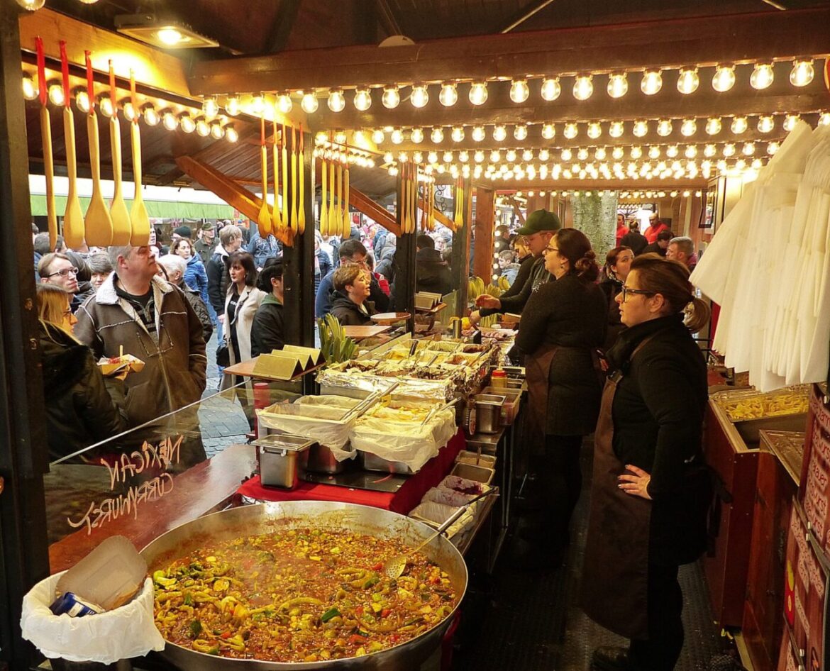 Currywurst-Festival_2020-01-31_Franz-Josef Dehenn_48 Menschen genießen Currywurst auf einem Festivalstand.